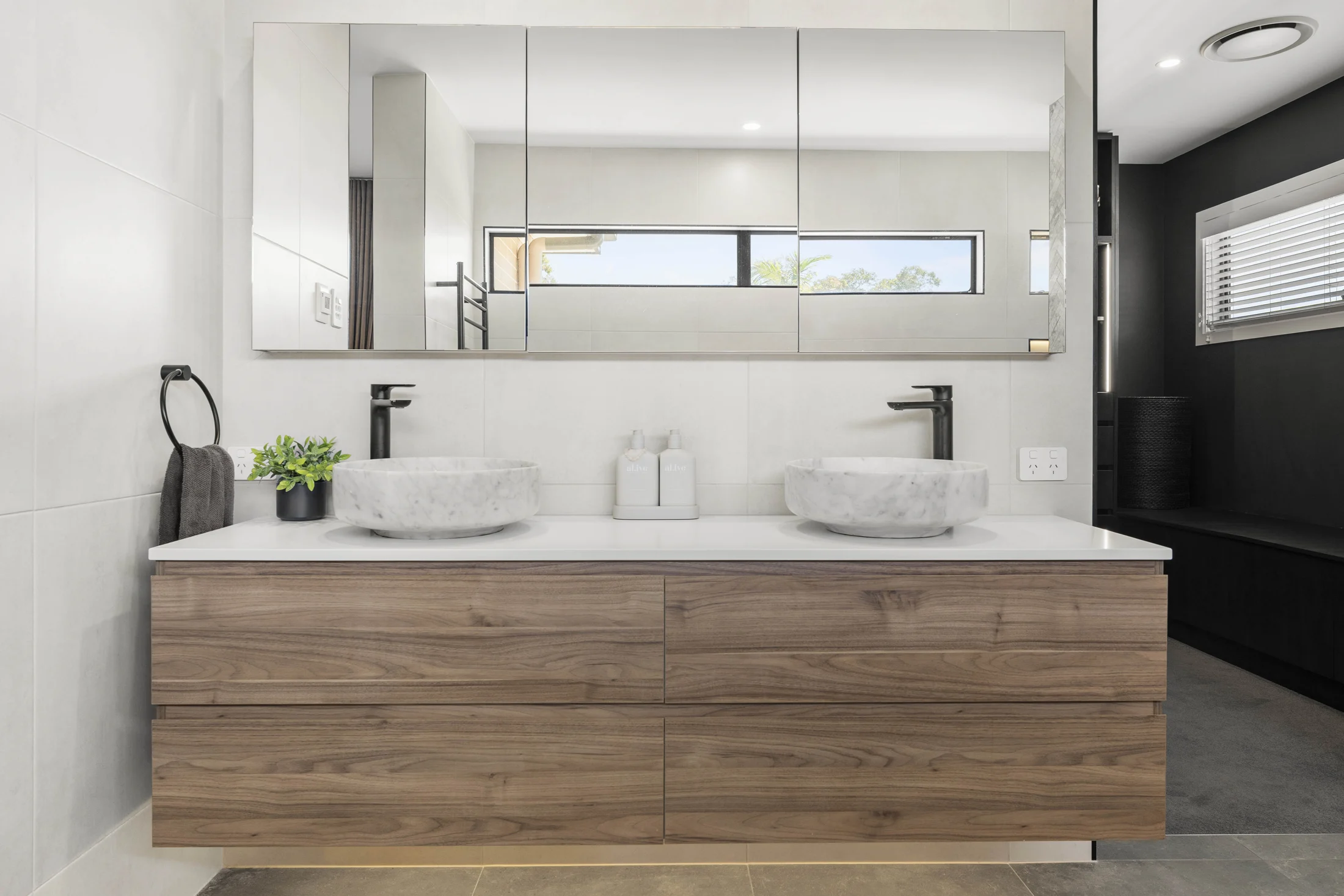 Twin marble bowl basins and herringbone marble feature wall